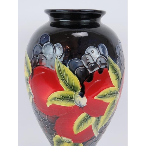 16 - A large pottery vase with grape and pomegranate design in the style of William Moorcroft. Imitation ... 