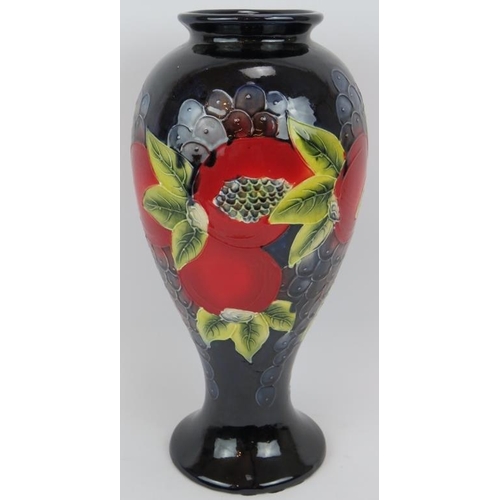 16 - A large pottery vase with grape and pomegranate design in the style of William Moorcroft. Imitation ... 