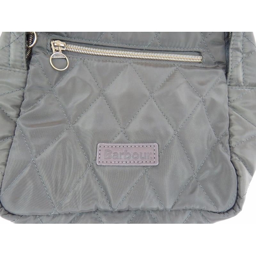 164 - An olive green quilted polyester Barbour backpack style hand bag. All handbags purchased direct from... 