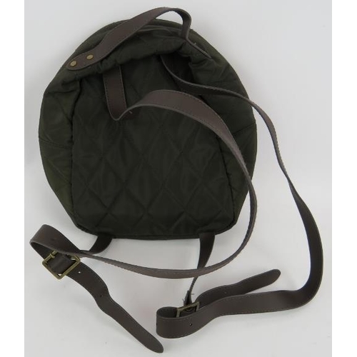 164 - An olive green quilted polyester Barbour backpack style hand bag. All handbags purchased direct from... 