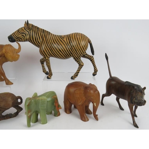 179 - Seven hand carved animal figures including wart hogs, zebra, water buffalo, impala, racoon and eleph... 