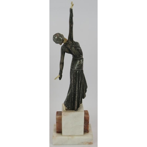 22 - An Art Deco style figure of a dancer in the style of Chiparus mounted on a marble plinth. Height 42c... 