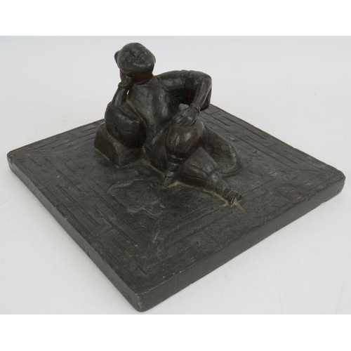 34 - An antique Chinese bluestone carving of a reclining female with bound feet in the centre of a slab w... 