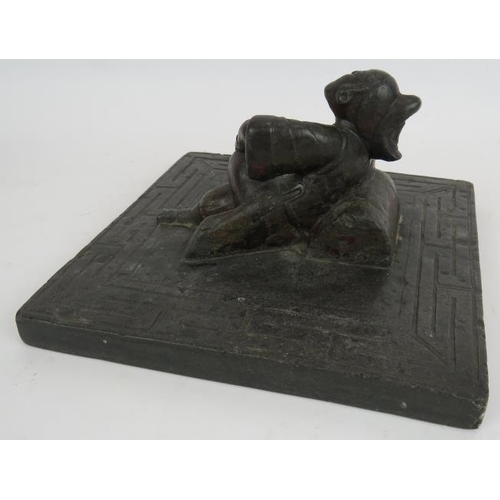 34 - An antique Chinese bluestone carving of a reclining female with bound feet in the centre of a slab w... 