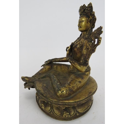 35 - A fine antique gilt bronze Buddha figure of Tibetan deity Tara seated on a lotus leaf base. The base... 