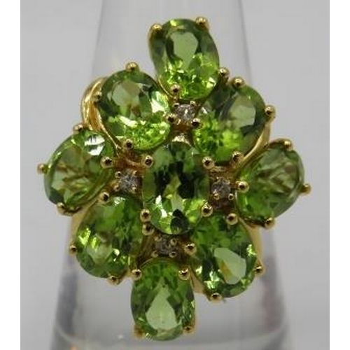 368 - A large peridot ring, setting 25mm x 20mm, size Q, oval brilliant cut stones, good cut, colour & cla... 