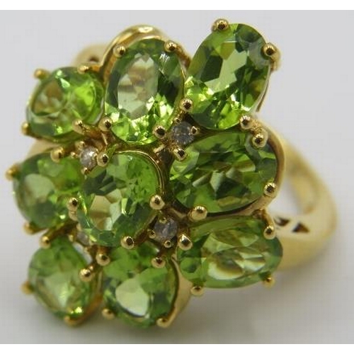 368 - A large peridot ring, setting 25mm x 20mm, size Q, oval brilliant cut stones, good cut, colour & cla... 