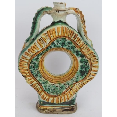 37 - An early European Majolica pottery flask in green and amber tin glaze and with twin pinched handles.... 