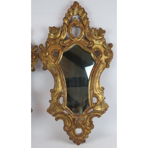 43 - An ornate pair of early 20th century gilt wood Venetian style mirrors, one with bevelled glass. Heig... 