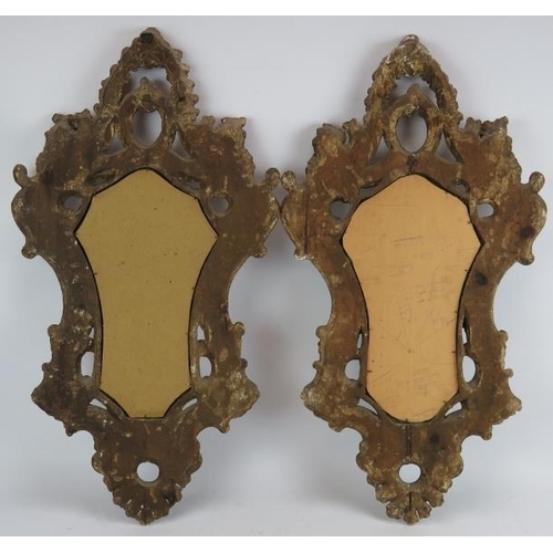 43 - An ornate pair of early 20th century gilt wood Venetian style mirrors, one with bevelled glass. Heig... 