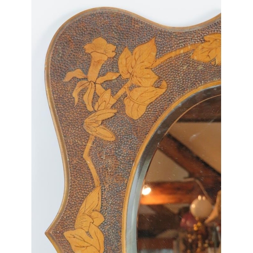 47 - An Edwardian pokerwork framed mirror with flowering vine design surrounding a bevelled oval mirror. ... 