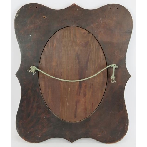 47 - An Edwardian pokerwork framed mirror with flowering vine design surrounding a bevelled oval mirror. ... 