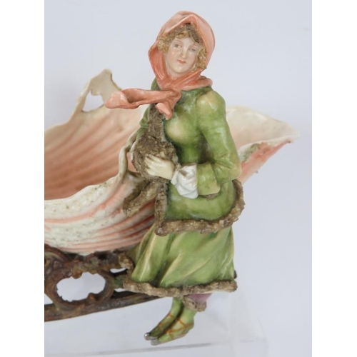 62 - A late 19th century continental porcelain figure of a girl with shell shaped sleigh, blue crossed ma... 