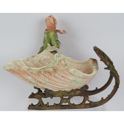 62 - A late 19th century continental porcelain figure of a girl with shell shaped sleigh, blue crossed ma... 