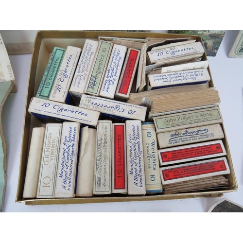 65 - A collection of cigarette cards in boxes, a 19th century autograph album, Cranbrook and area postcar... 