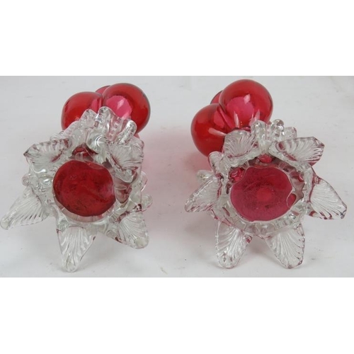 84 - A pair of Victorian triple lobed cranberry glass garnitures, three pieces of hand enamelled and gild... 