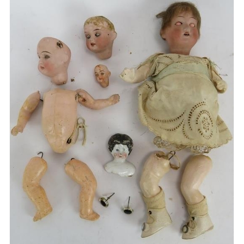 88 - A small selection of mixed antique doll parts including five heads, 4 marked, plus a small jointed e... 