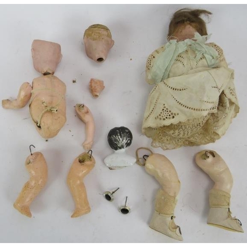 88 - A small selection of mixed antique doll parts including five heads, 4 marked, plus a small jointed e... 