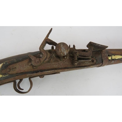 9 - An Antique Middle-Eastern Jezail flint lock rifle with ornately inlaid bone and brass stock, Length:... 