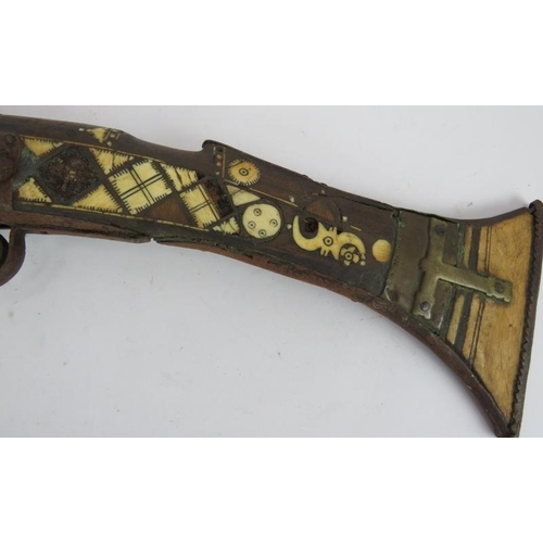 9 - An Antique Middle-Eastern Jezail flint lock rifle with ornately inlaid bone and brass stock, Length:... 