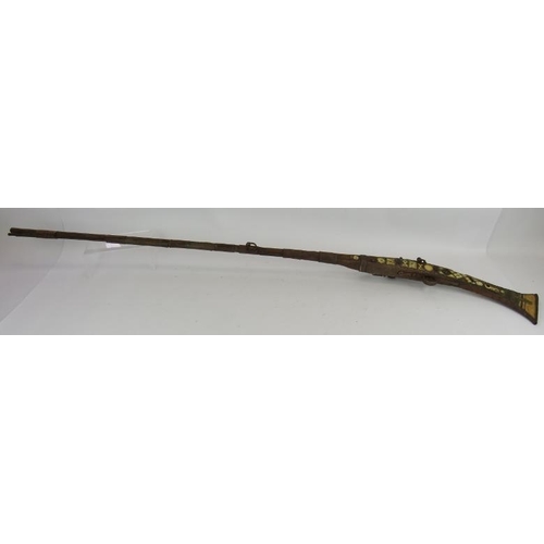 9 - An Antique Middle-Eastern Jezail flint lock rifle with ornately inlaid bone and brass stock, Length:... 