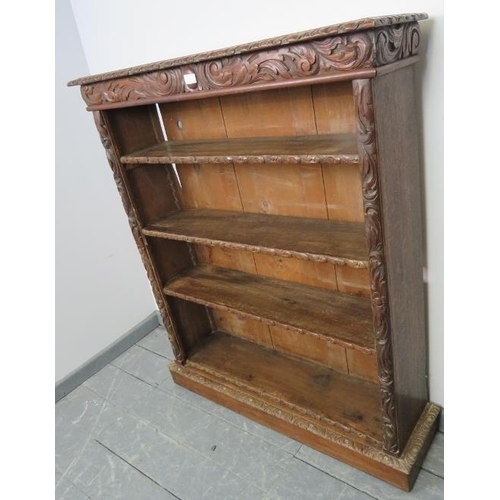 704 - A 19th century oak tall open bookcase of three height adjustable shelves, featuring acanthus relief ... 