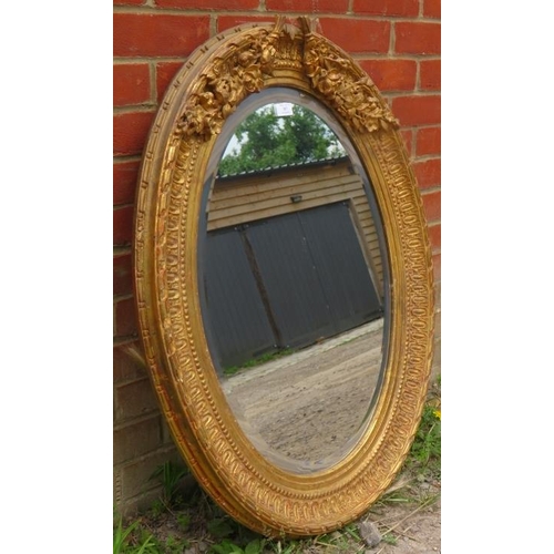 707 - A 19th century French style bevelled oval wall mirror in an ornate gilt gesso frame.
Condition repor... 