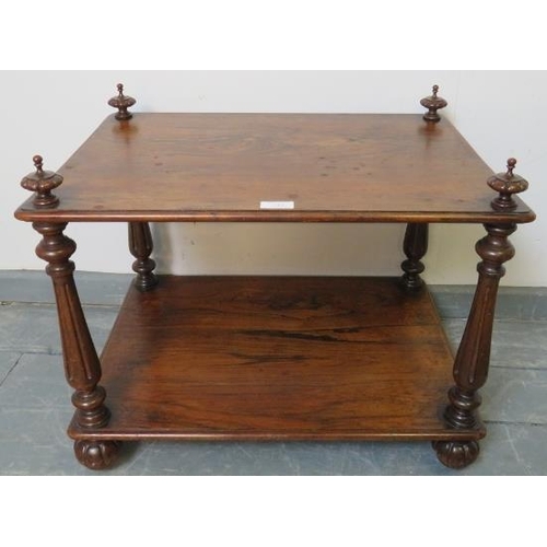 710 - A Victorian rosewood two tier whatnot, with finials and reeded uprights, on fluted ball feet with re... 