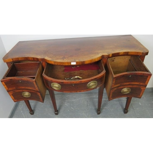 714 - A George III mahogany serpentine front sideboard, inlaid and crossbanded, with central long drawer a... 