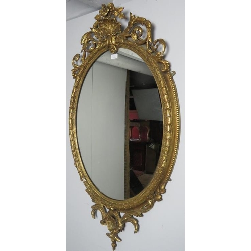 719 - A very ornate 19th century gilt gesso oval wall mirror, with acanthus scrolled shell cornice. 
Condi... 