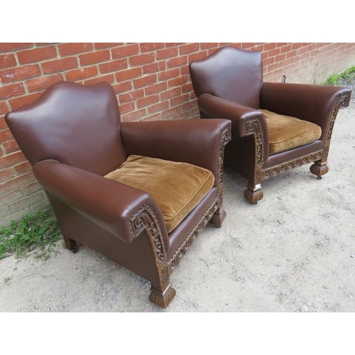 721 - A pair of good turn of the century carved oak framed club armchairs, upholstered in brown leather wi... 