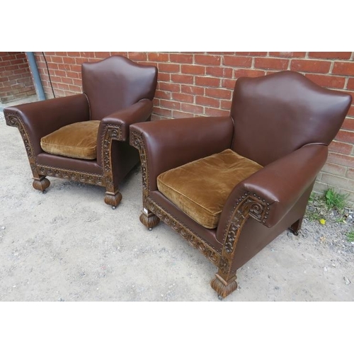 721 - A pair of good turn of the century carved oak framed club armchairs, upholstered in brown leather wi... 