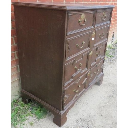 722 - An antique oak chest in the Jacobean style, having two short over three long graduated drawers, with... 