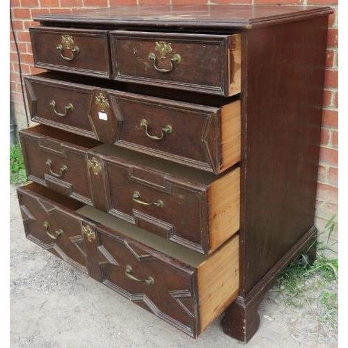 722 - An antique oak chest in the Jacobean style, having two short over three long graduated drawers, with... 