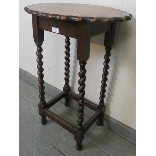 727 - A vintage oak oval occasional table with piecrust edge, on barley twist supports with stretchers. 
C... 