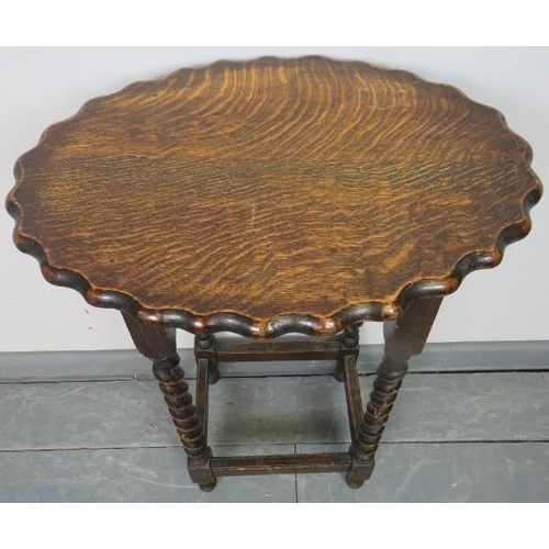 727 - A vintage oak oval occasional table with piecrust edge, on barley twist supports with stretchers. 
C... 