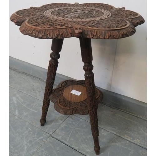 730 - A turn of the century hardwood Anglo Indian two-tier occasional table, with relief carving depicting... 