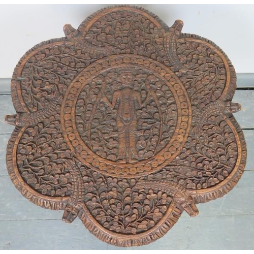 730 - A turn of the century hardwood Anglo Indian two-tier occasional table, with relief carving depicting... 