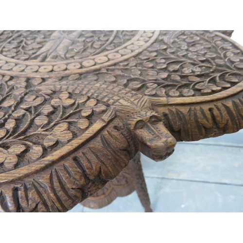 730 - A turn of the century hardwood Anglo Indian two-tier occasional table, with relief carving depicting... 