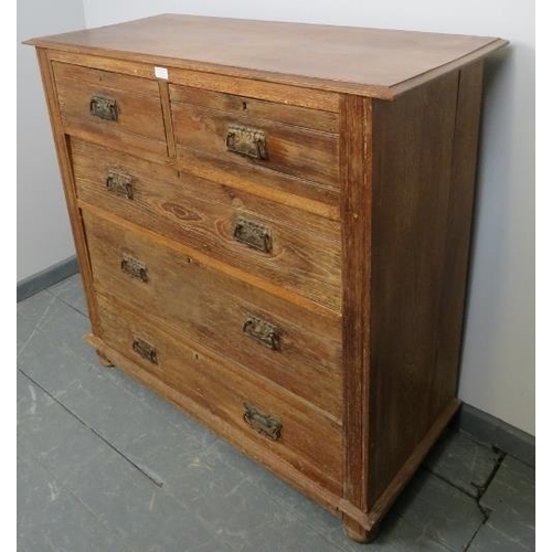 732 - An Edwardian limed oak chest of two short over three long graduated drawers, with pressed brass Art ... 