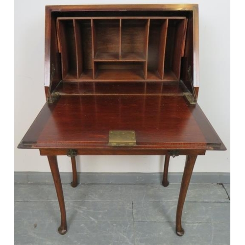 736 - A 1920s mahogany bureau, the fall front opening onto a fitted interior, over one long drawer, on cab... 