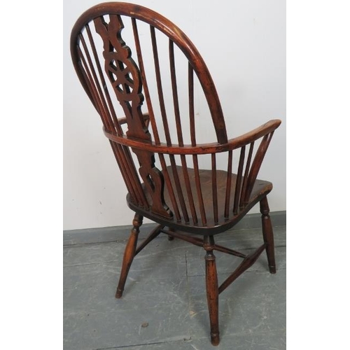 740 - A Georgian elm and yew wood hoop-back Windsor chair of excellent colour, on turned supports with an ... 