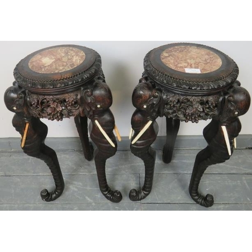 749 - A pair of antique tropical hardwood jardinieres/plant stands with inset red marble tops, the finely ... 