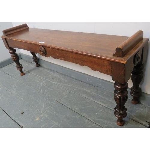 751 - A Victorian mahogany window seat, with shaped frieze and applied roundels, on tapering turned fluted... 