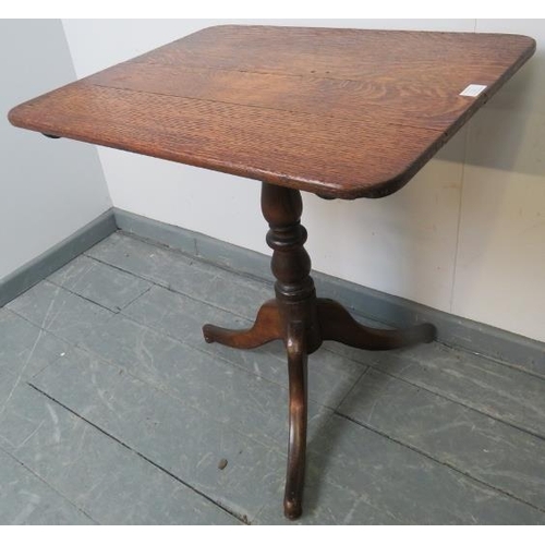 752 - A Georgian oak rectangular tilt-top wine table, on a baluster turned pedestal with tripod base. 
Con... 