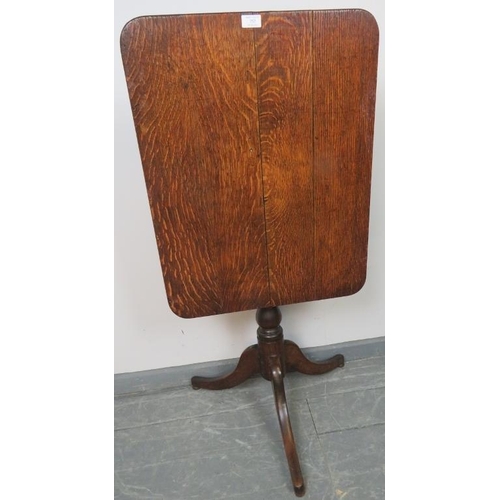 752 - A Georgian oak rectangular tilt-top wine table, on a baluster turned pedestal with tripod base. 
Con... 