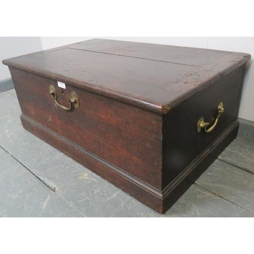 755 - A small 19th century oak flat top trunk, with brad handles to front and sides, on a plinth base. 
Co... 