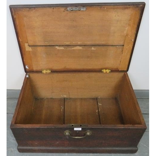 755 - A small 19th century oak flat top trunk, with brad handles to front and sides, on a plinth base. 
Co... 