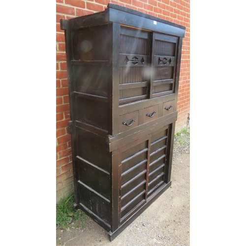 756 - An antique Japanese ebonised two section Mizuya Tansu (kitchen chest) housing three short drawers wi... 