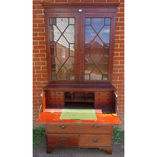 757 - A Georgian mahogany secretaire bookcase strung with satinwood, the top section with astral glazed do... 